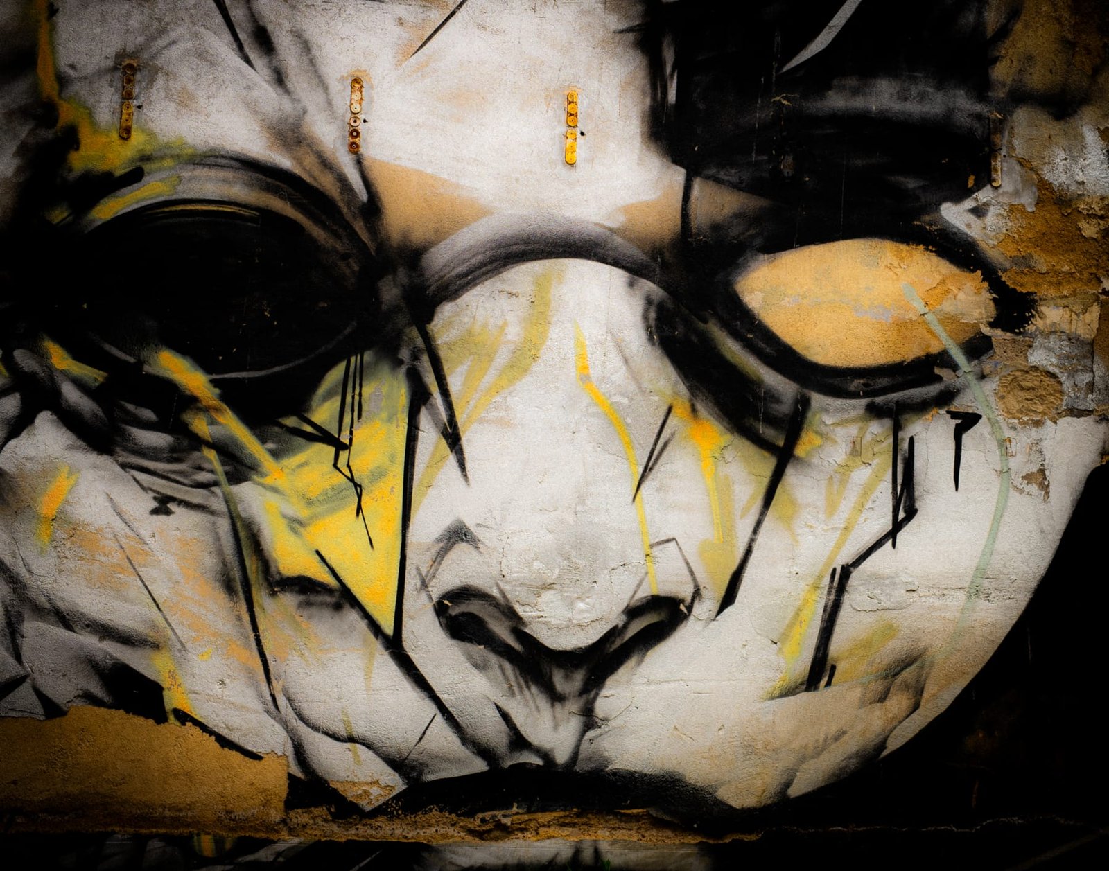 Street art urbex, visage masqué peint sur un mur